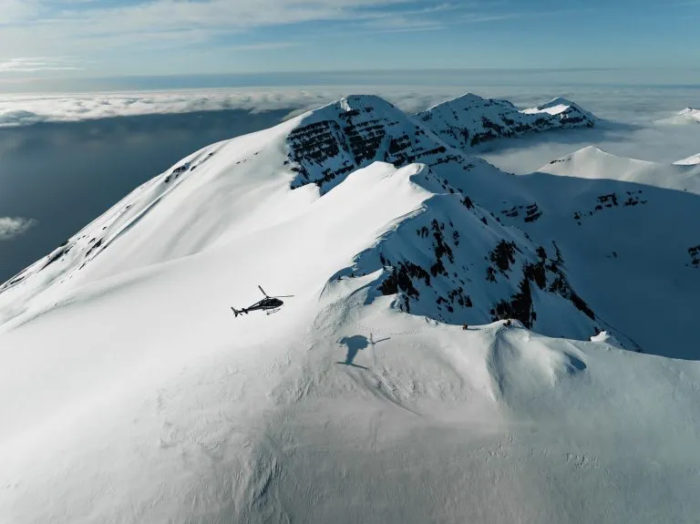 helicopter over snowy mountains
