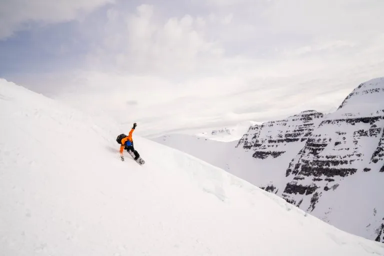 snowboarder carving mountain slope